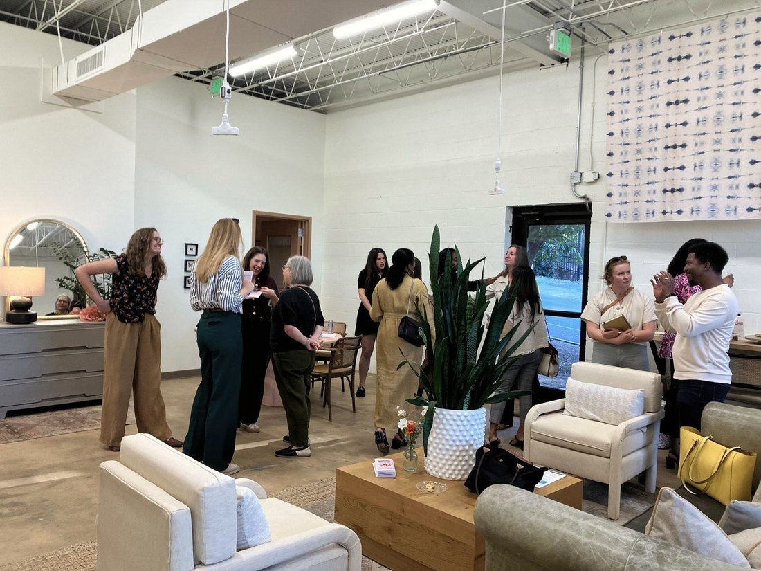 People talking in a bright open room