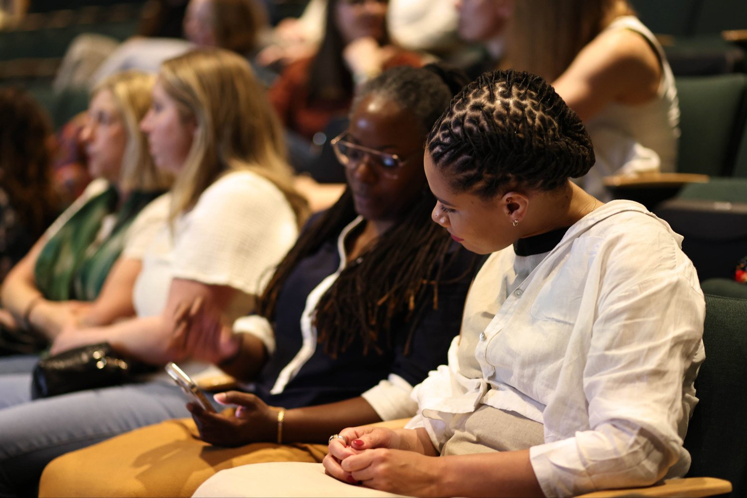 A seated audience listening at an event